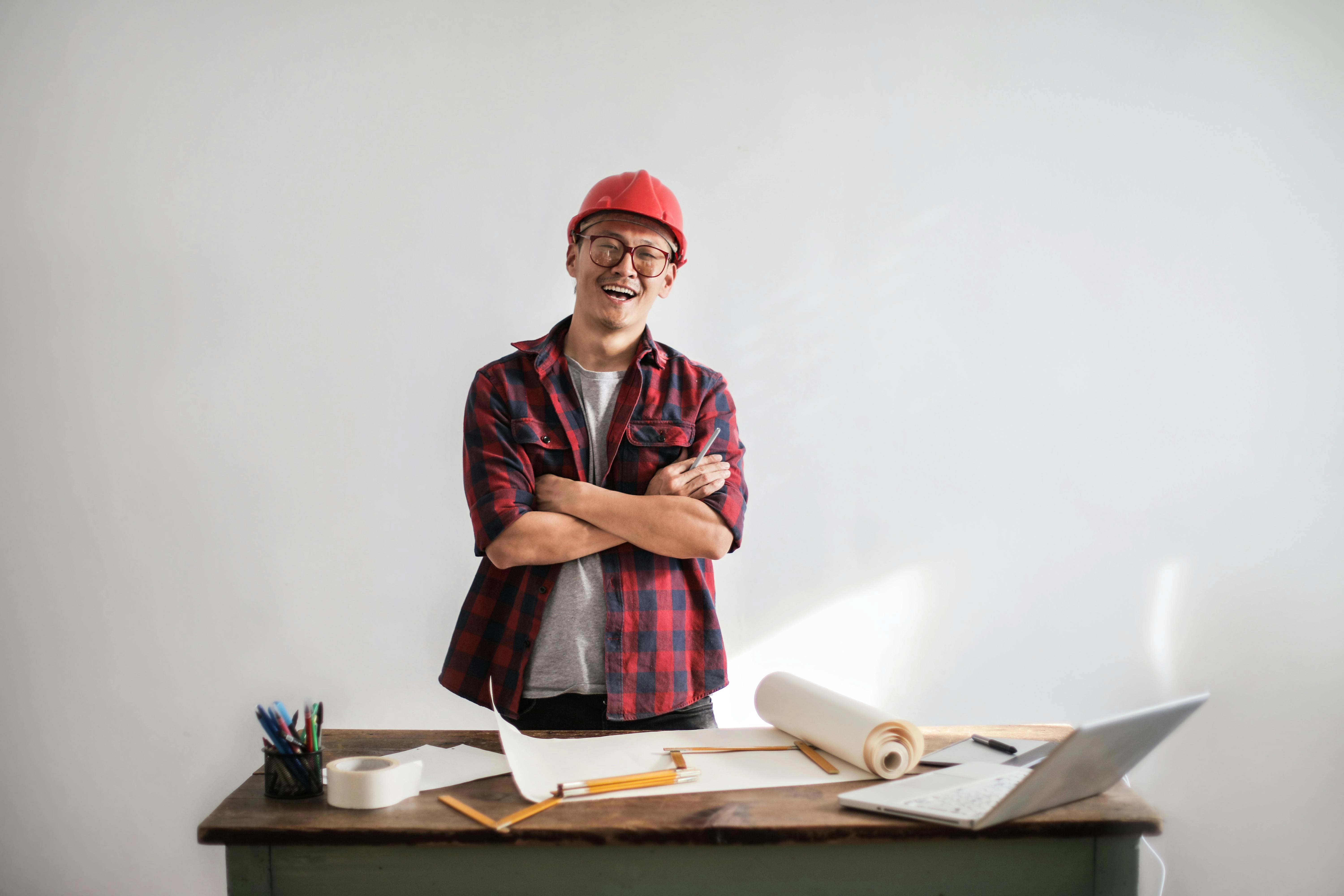 Cheerful architect with blueprints Cheerful architect with blueprints