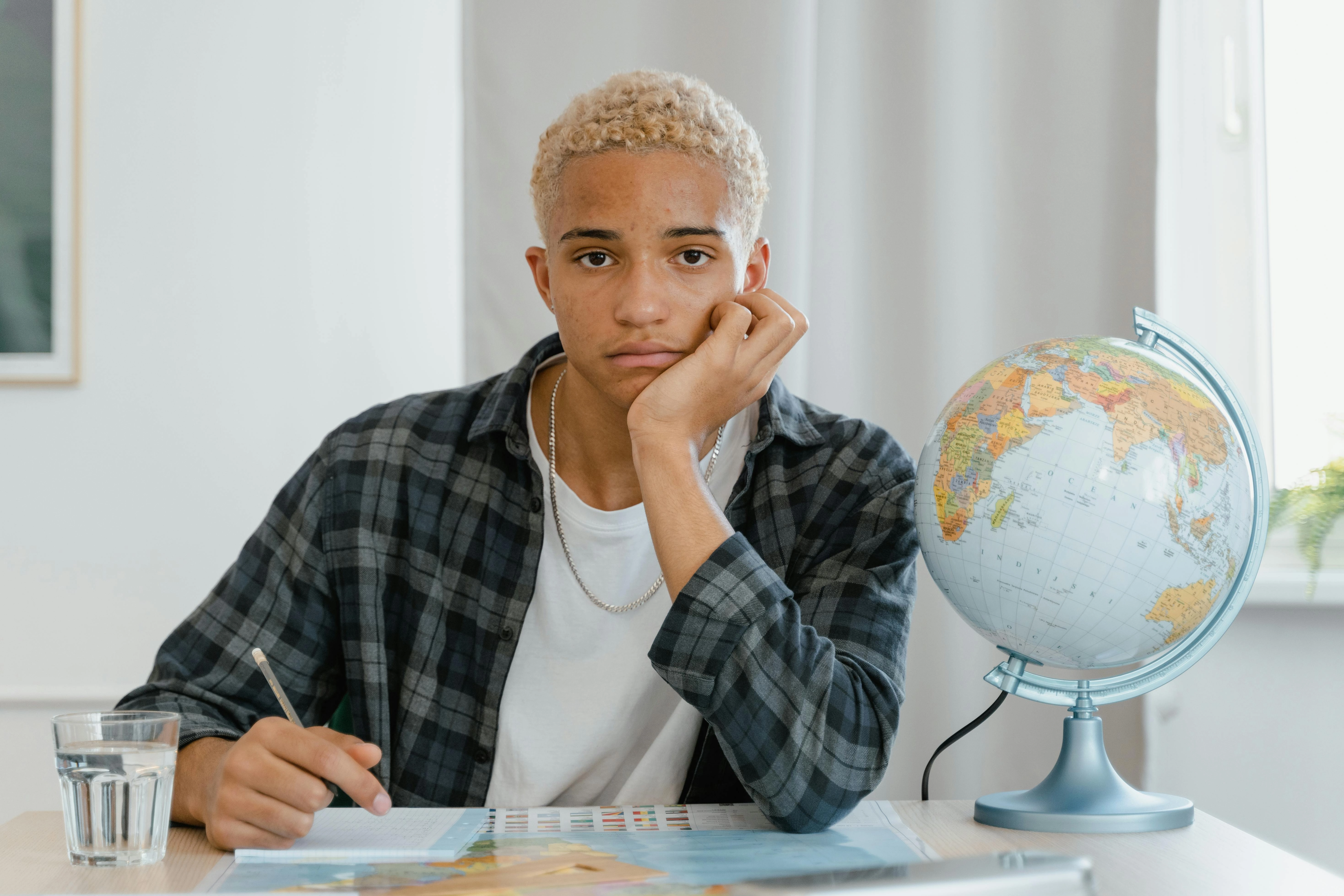 Contemplative Student with Globe