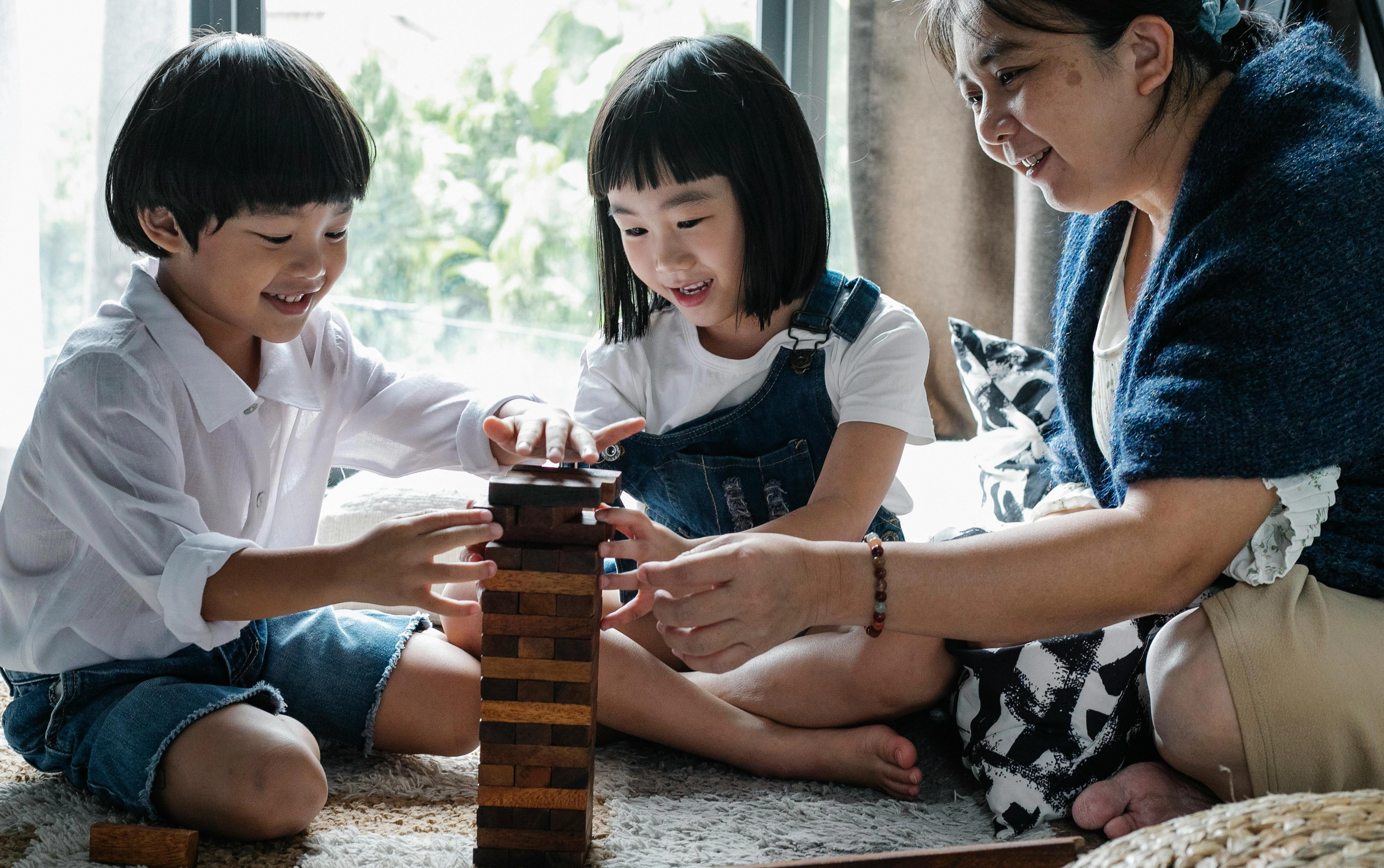 Family playing wooden block game Family playing wooden block game