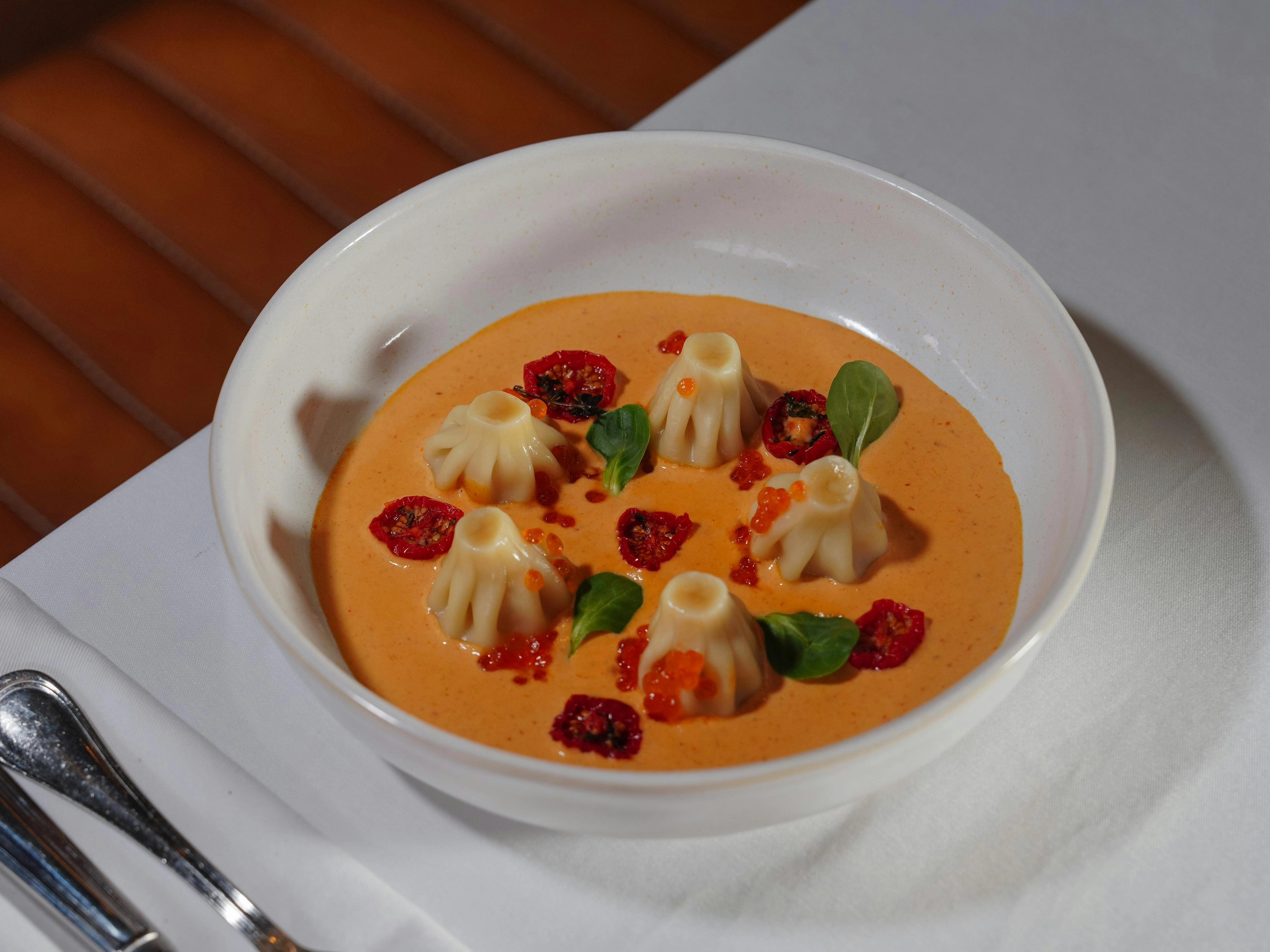 Gourmet Dumplings in Orange Soup