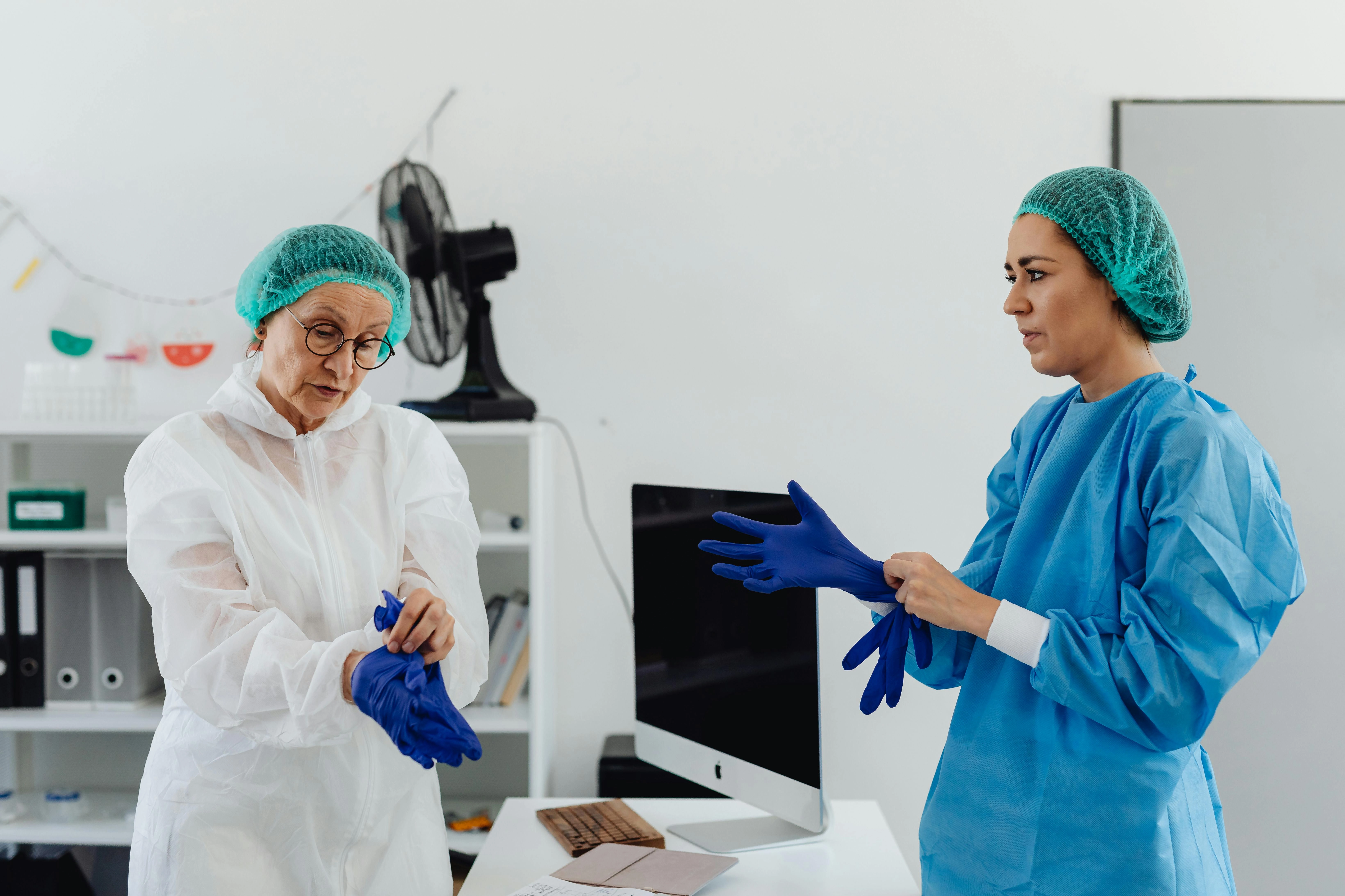 Medical professionals preparing gloves