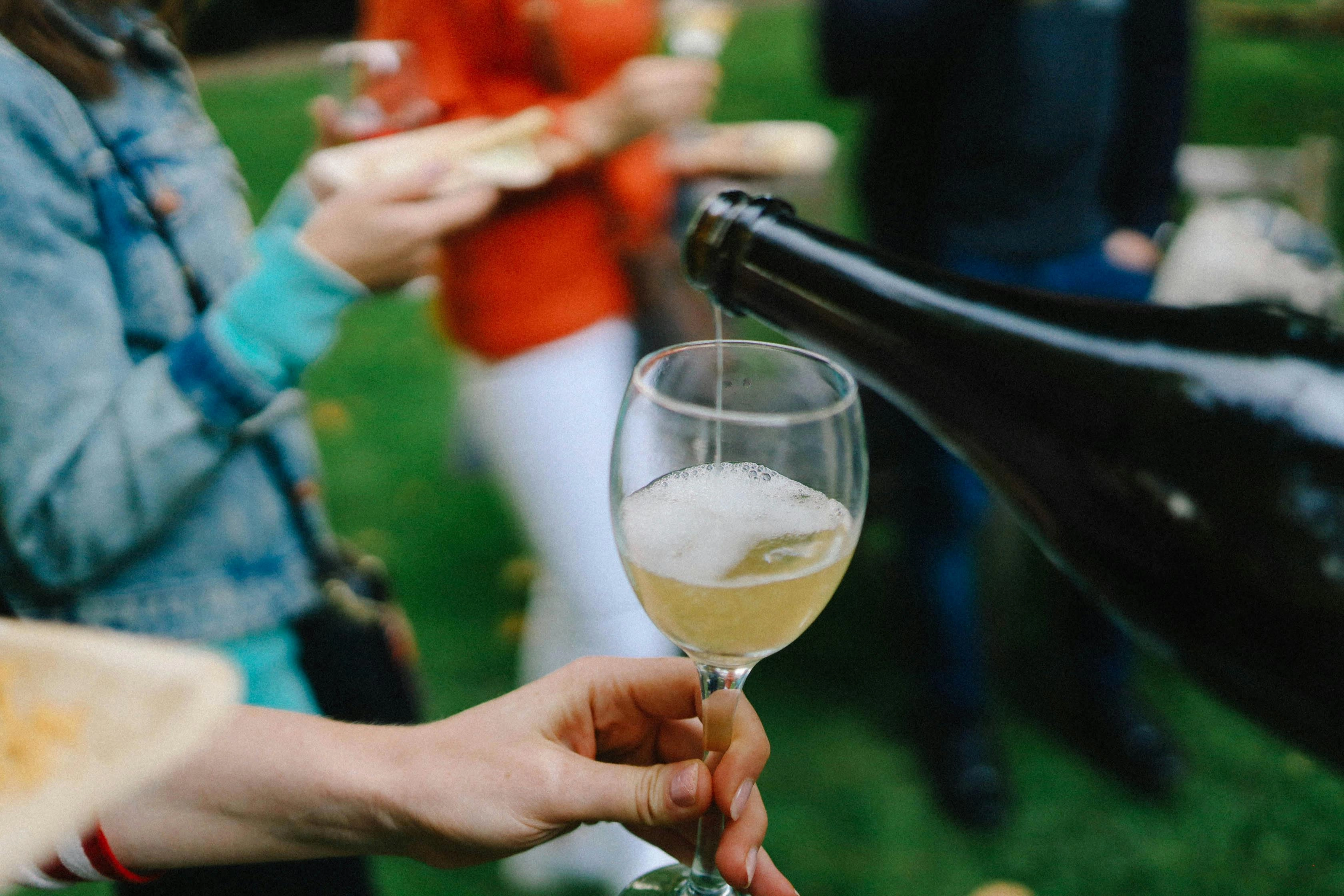 Pouring champagne at gathering Pouring champagne at gathering