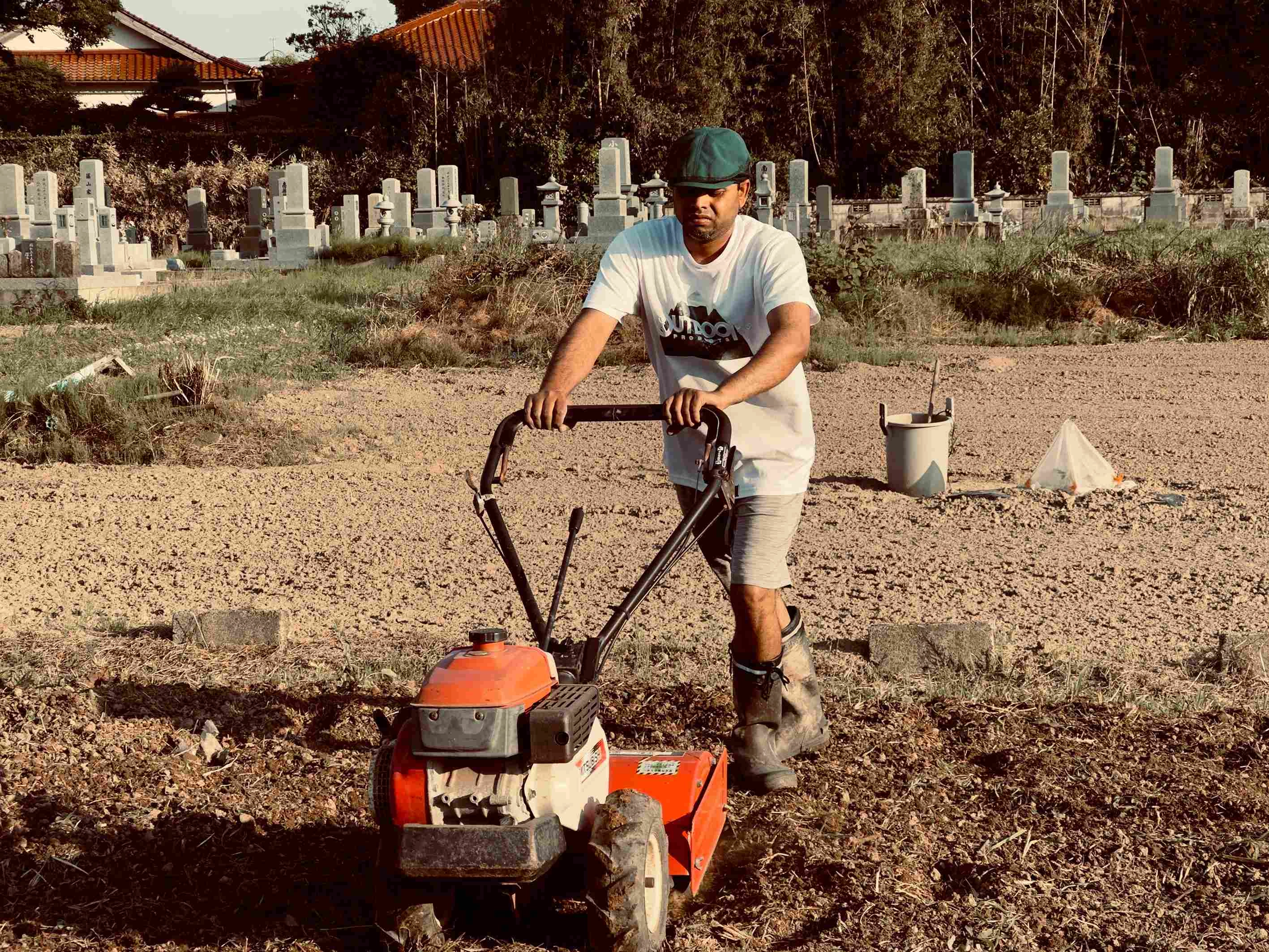 Groundskeeper tilling cemetery soil