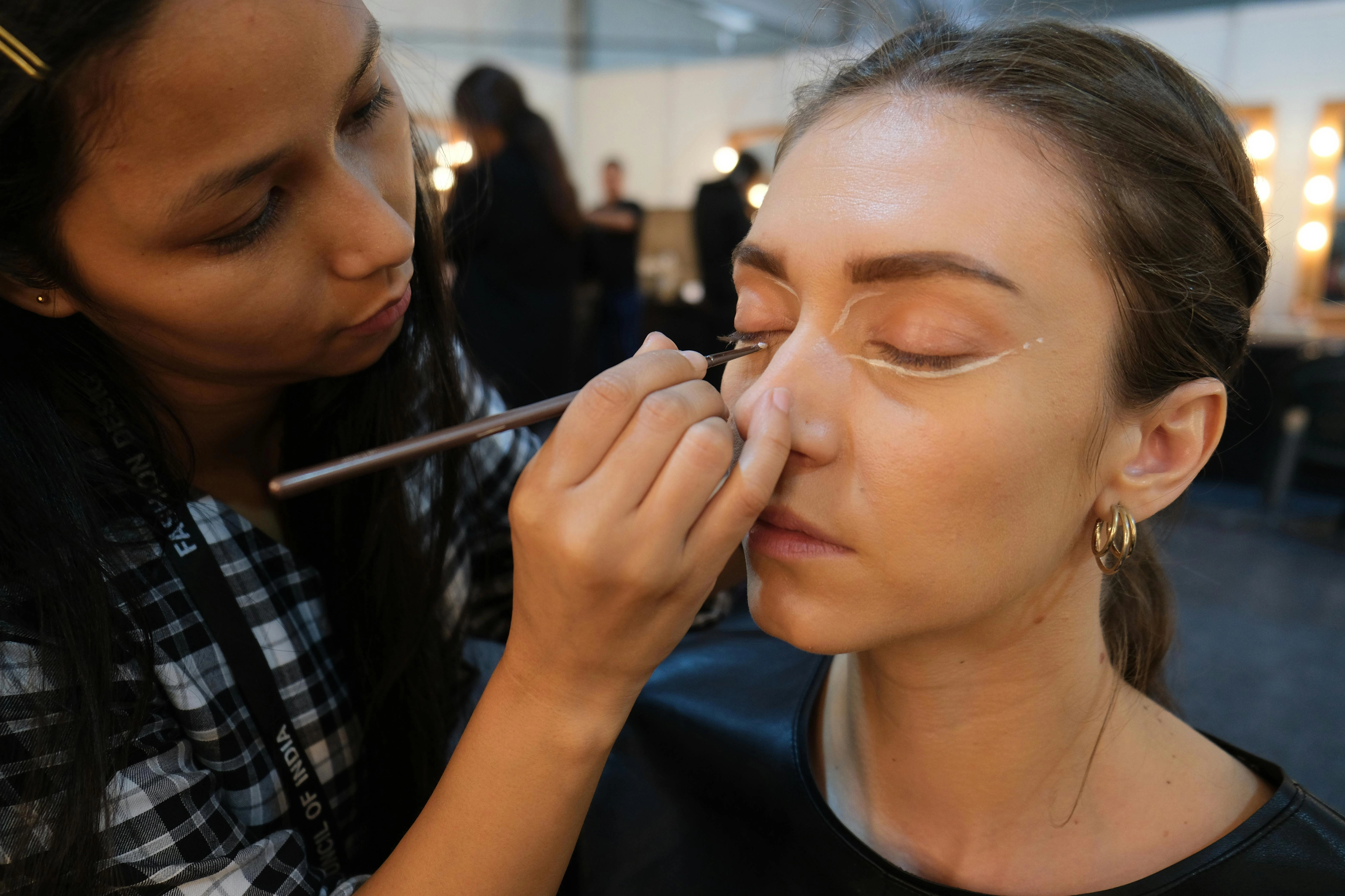 Makeup Artist Applying Eyeliner