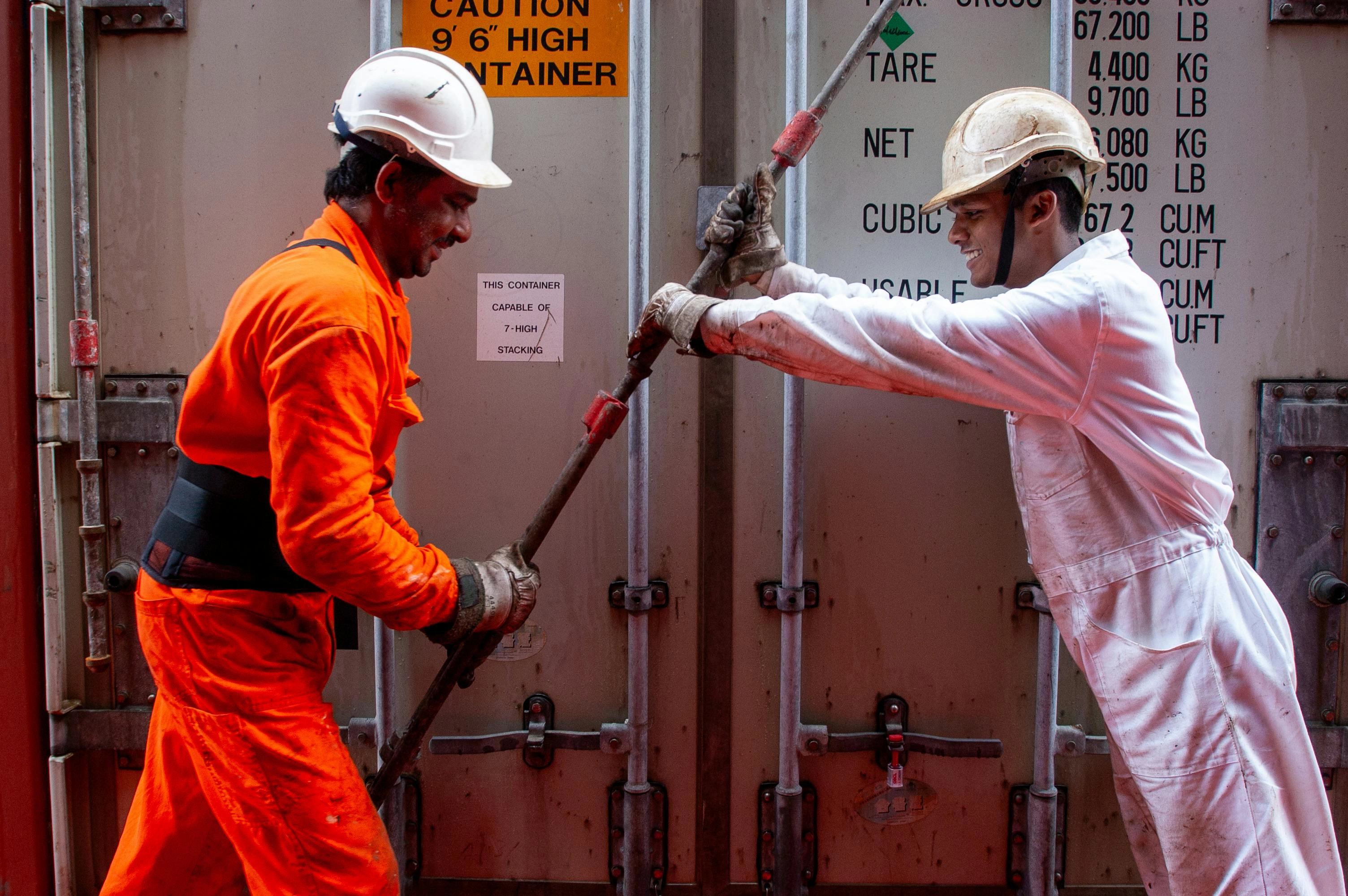 Dockworkers Collaborating on Container