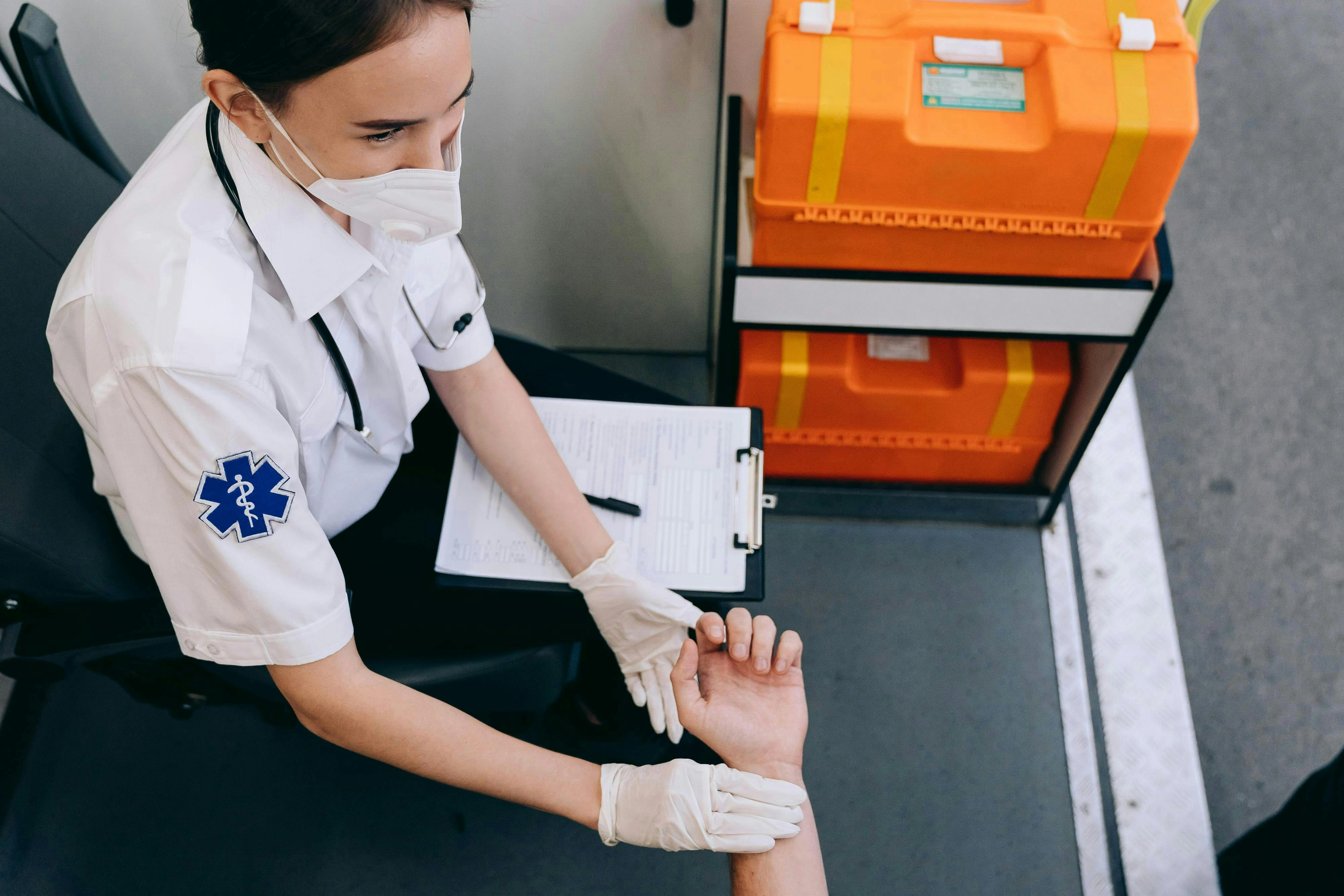 Paramedic Checking Patient's Pulse