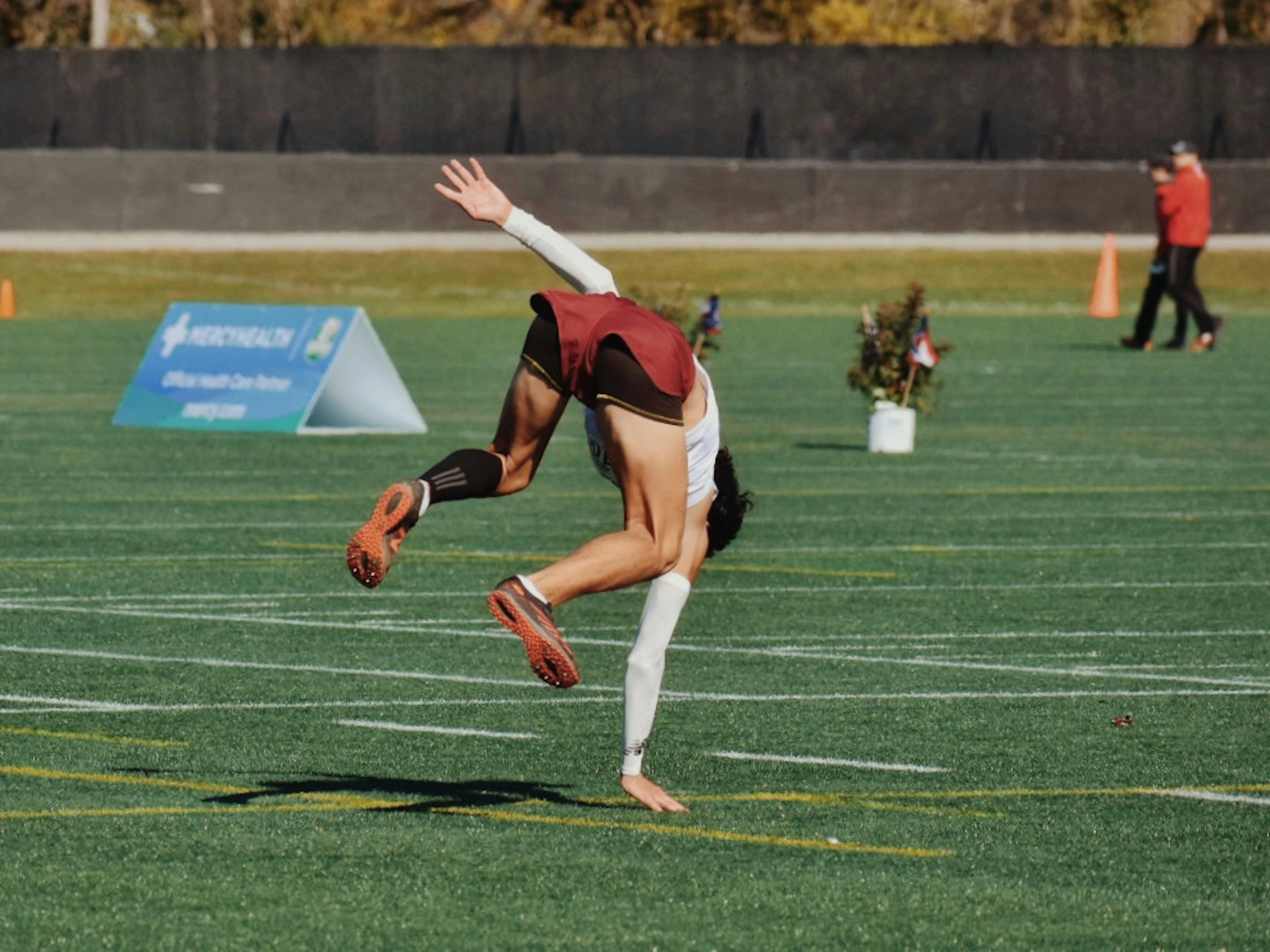 Acrobatic athlete mid-backflip Acrobatic athlete mid-backflip