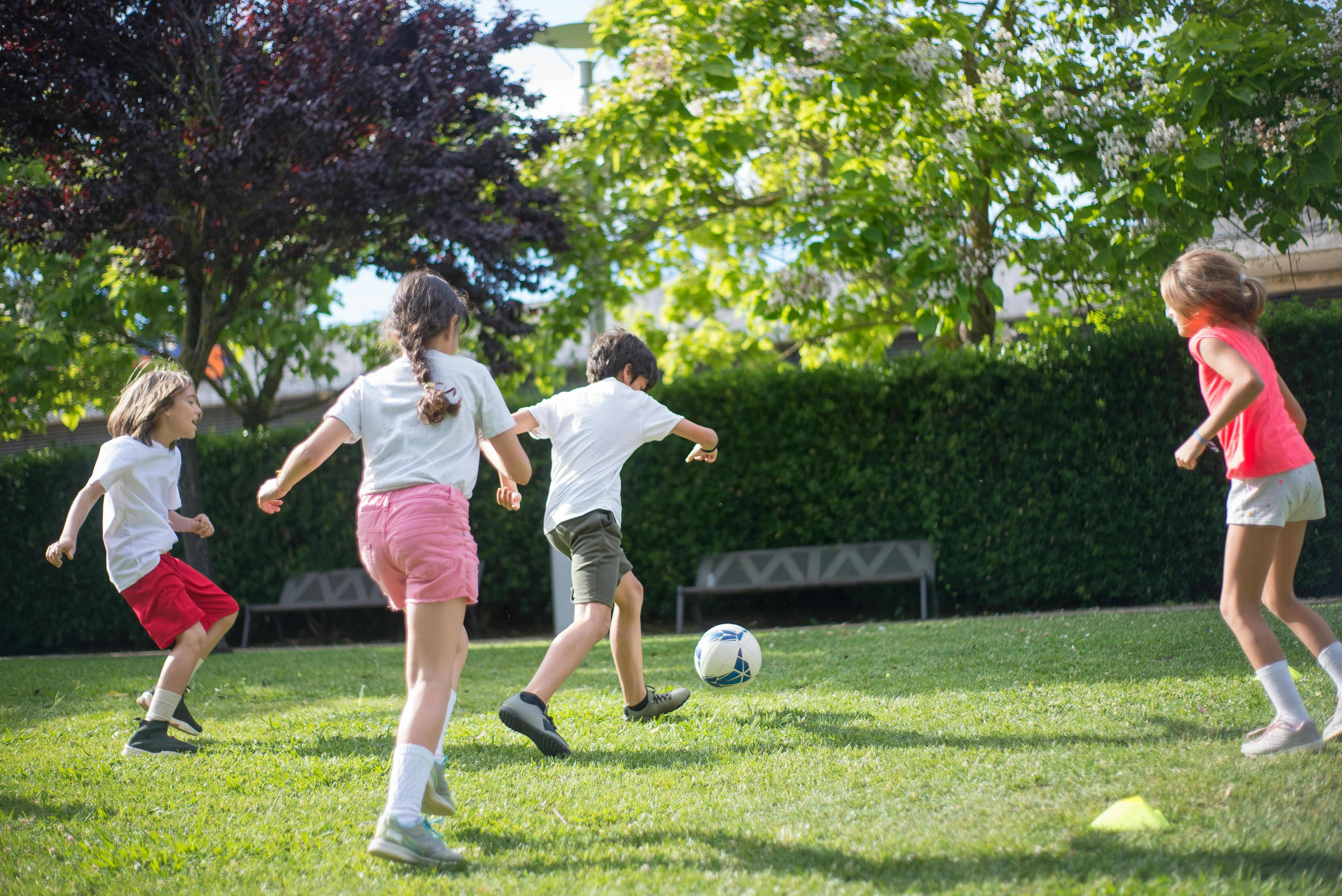 Children Playing Soccer Outdoors Children Playing Soccer Outdoors