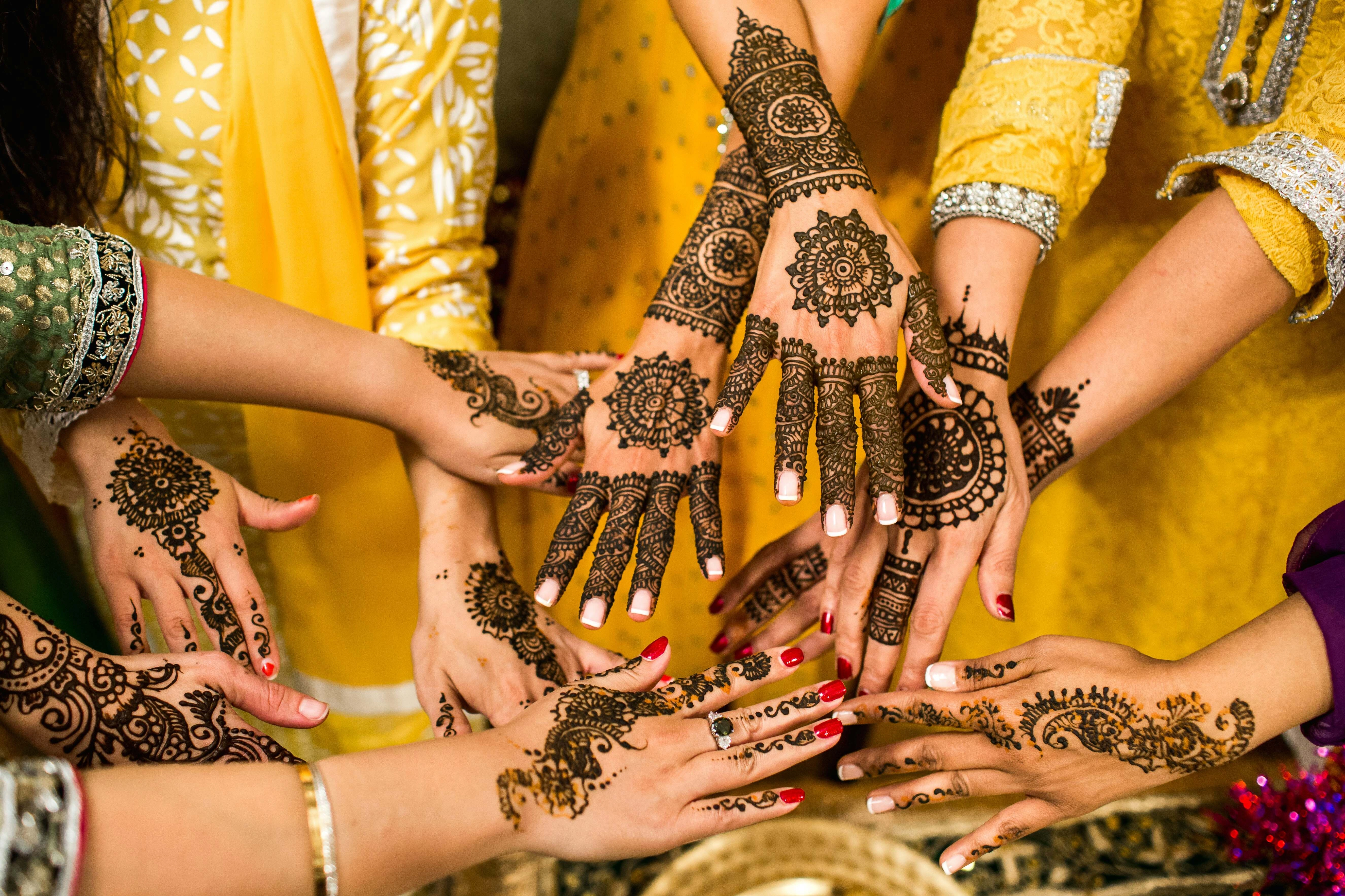 Henna-Adorned Hands in Yellow Henna-Adorned Hands in Yellow