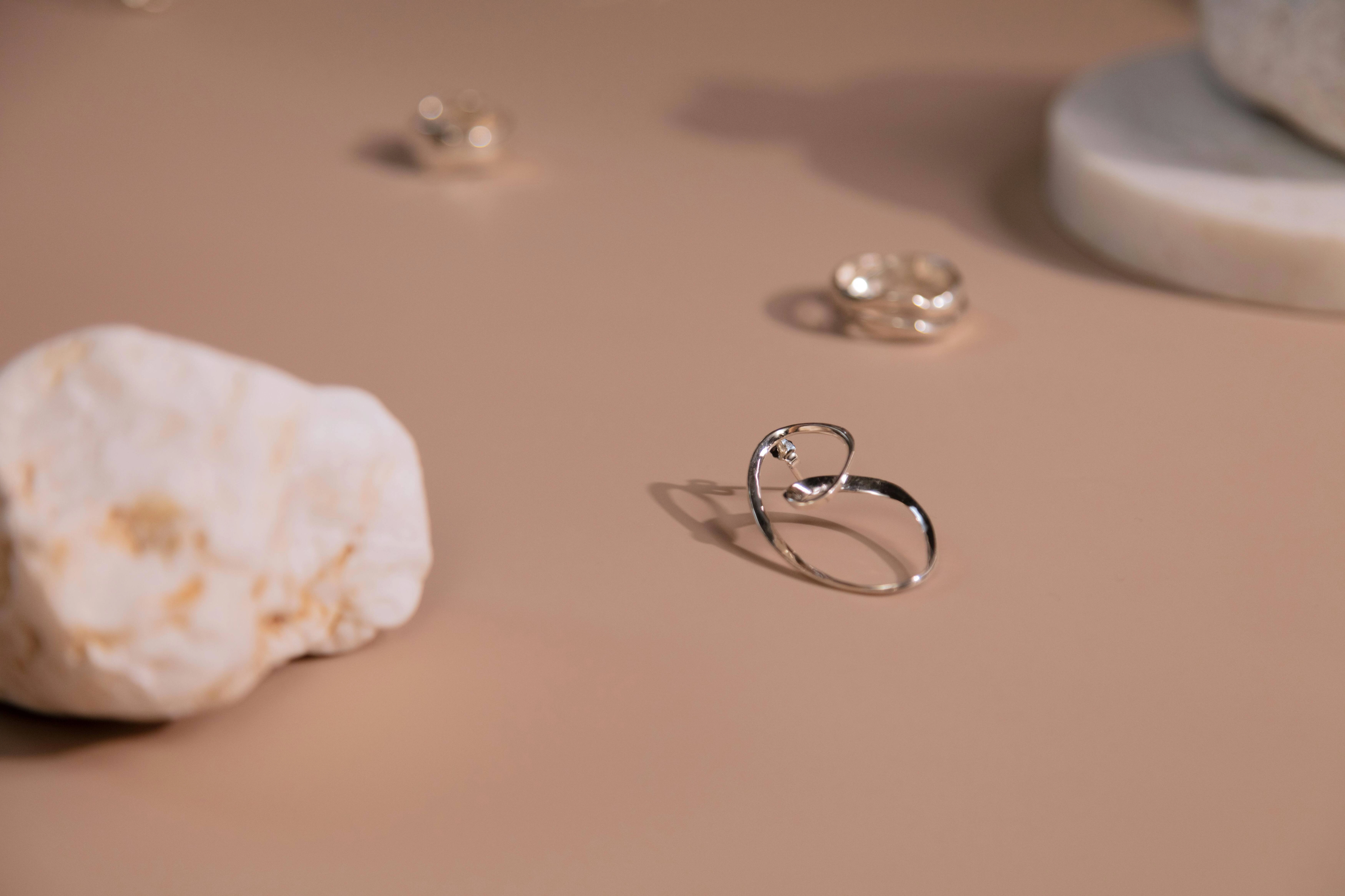 Delicate jewelry on beige surface