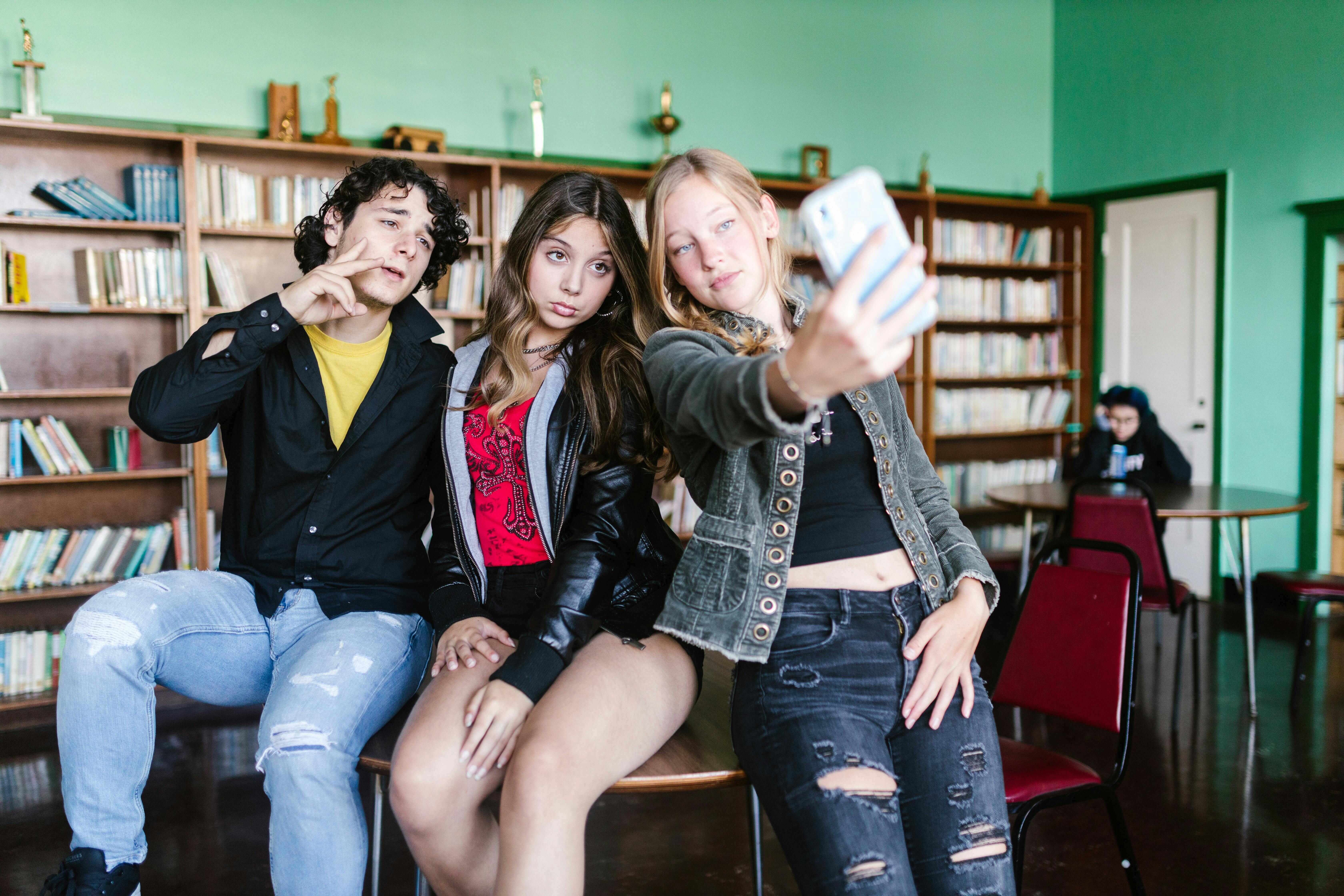 Teens taking library selfie Teens taking library selfie