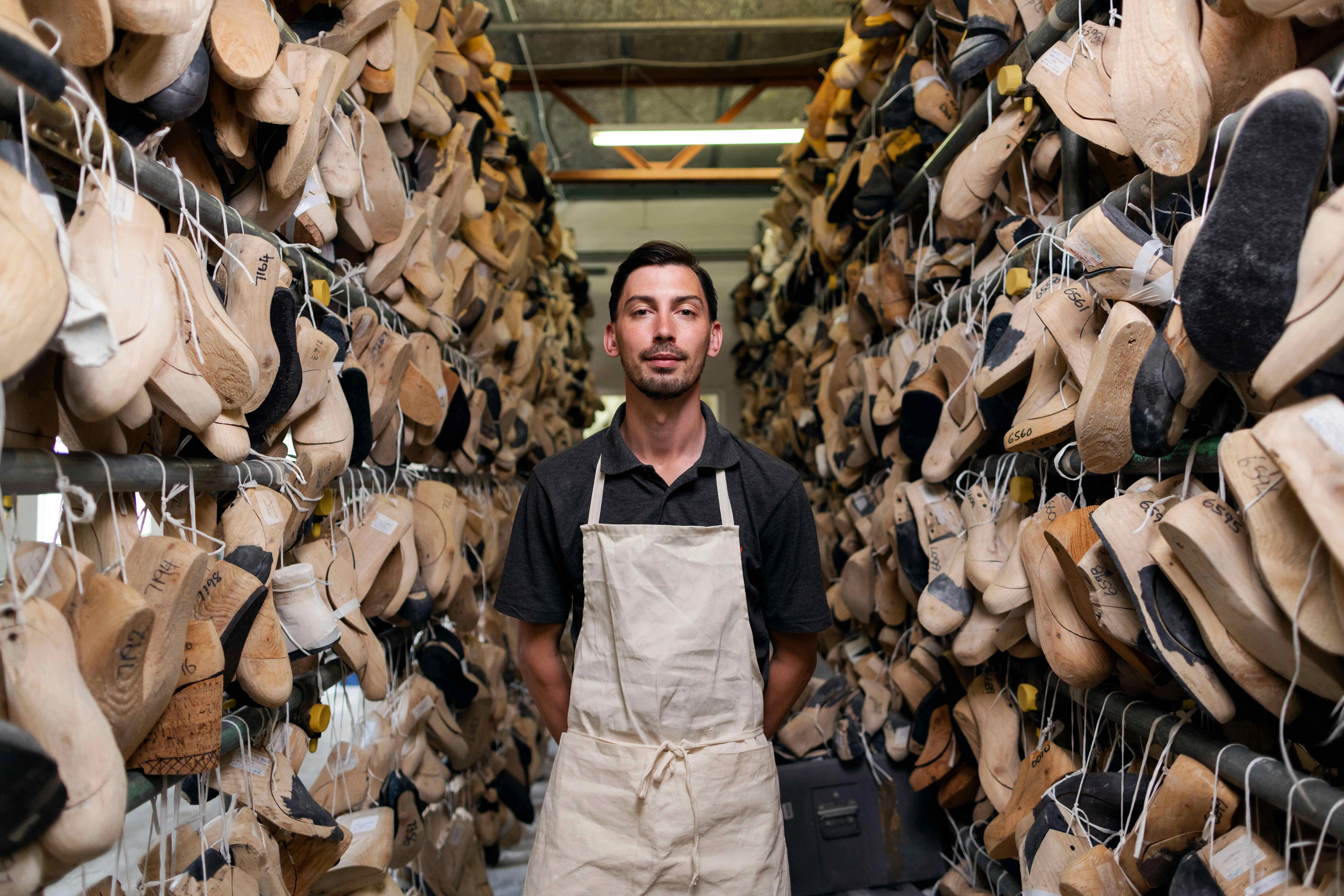 Shoemaker in workshop aisle Shoemaker in workshop aisle