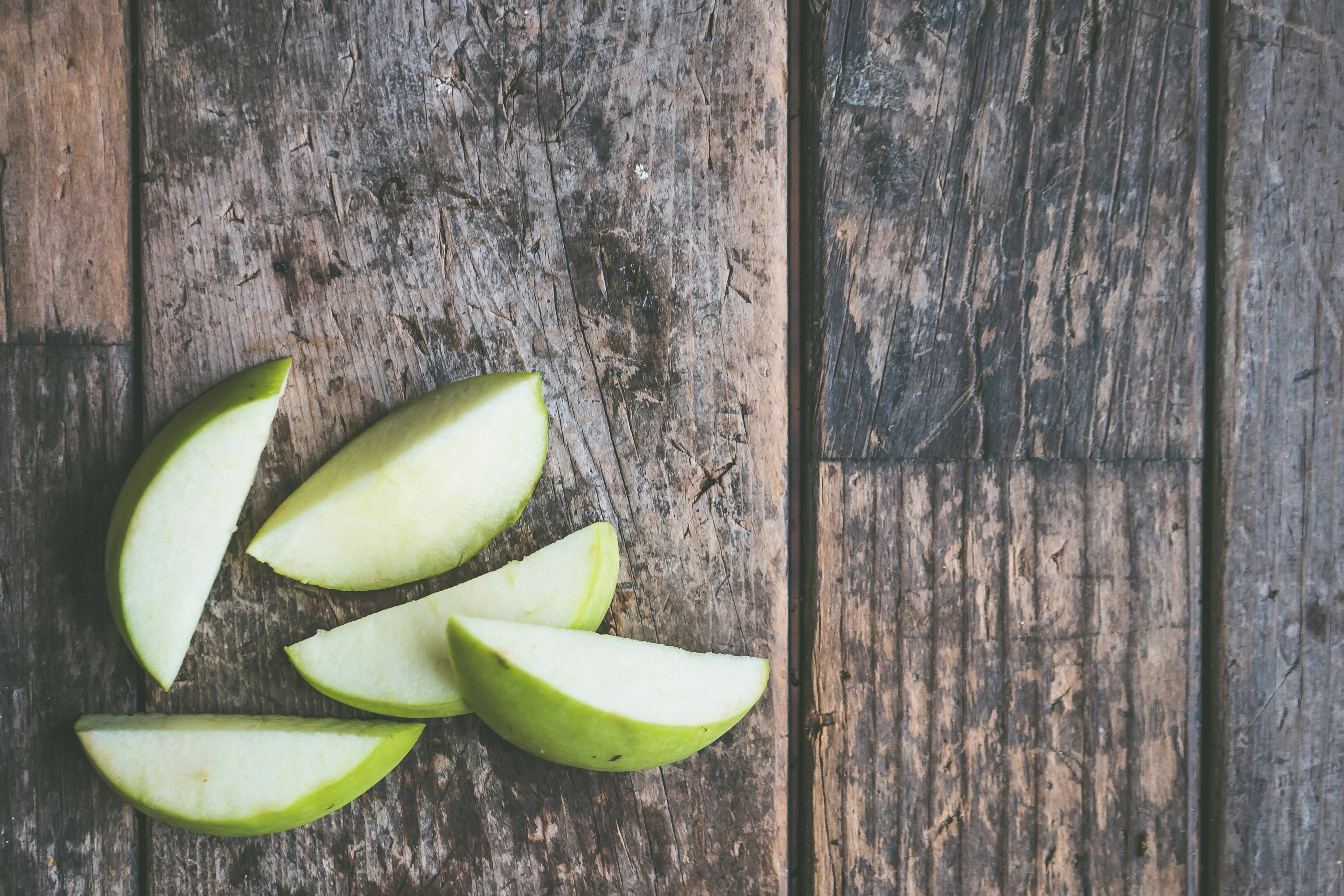 Sliced Green Apples on Wood Sliced Green Apples on Wood