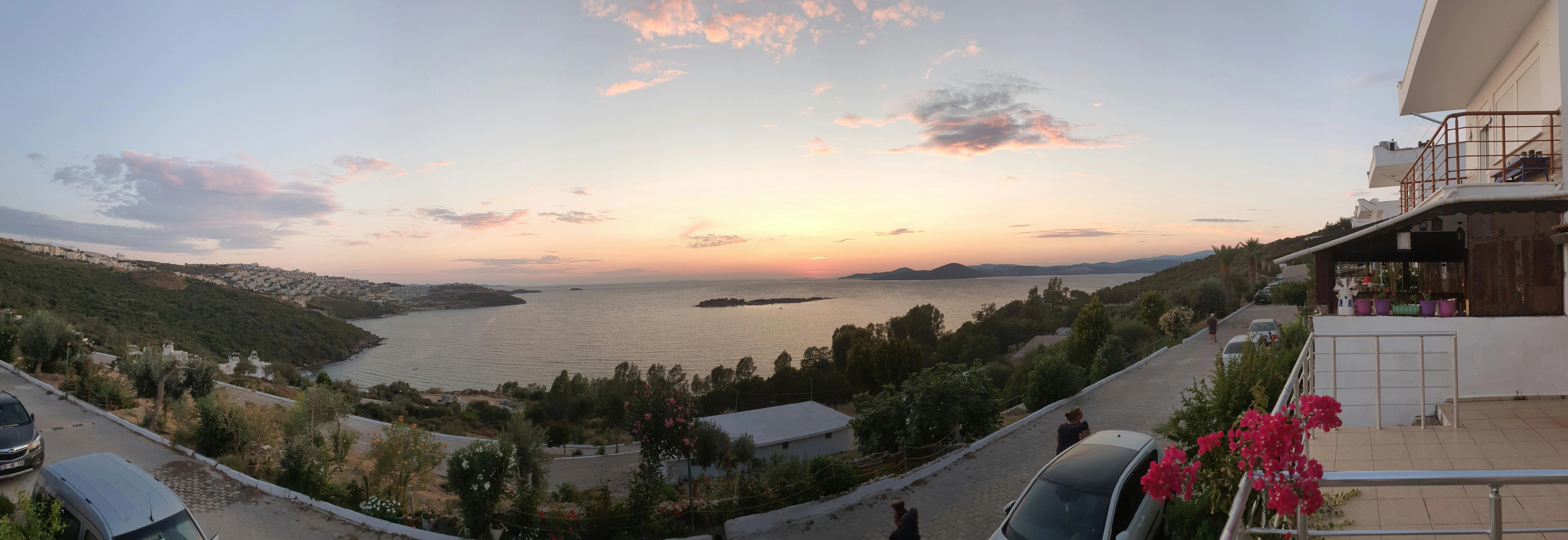 a-view-of-a-sunset-over-a-body-of-water a-view-of-a-sunset-over-a-body-of-water