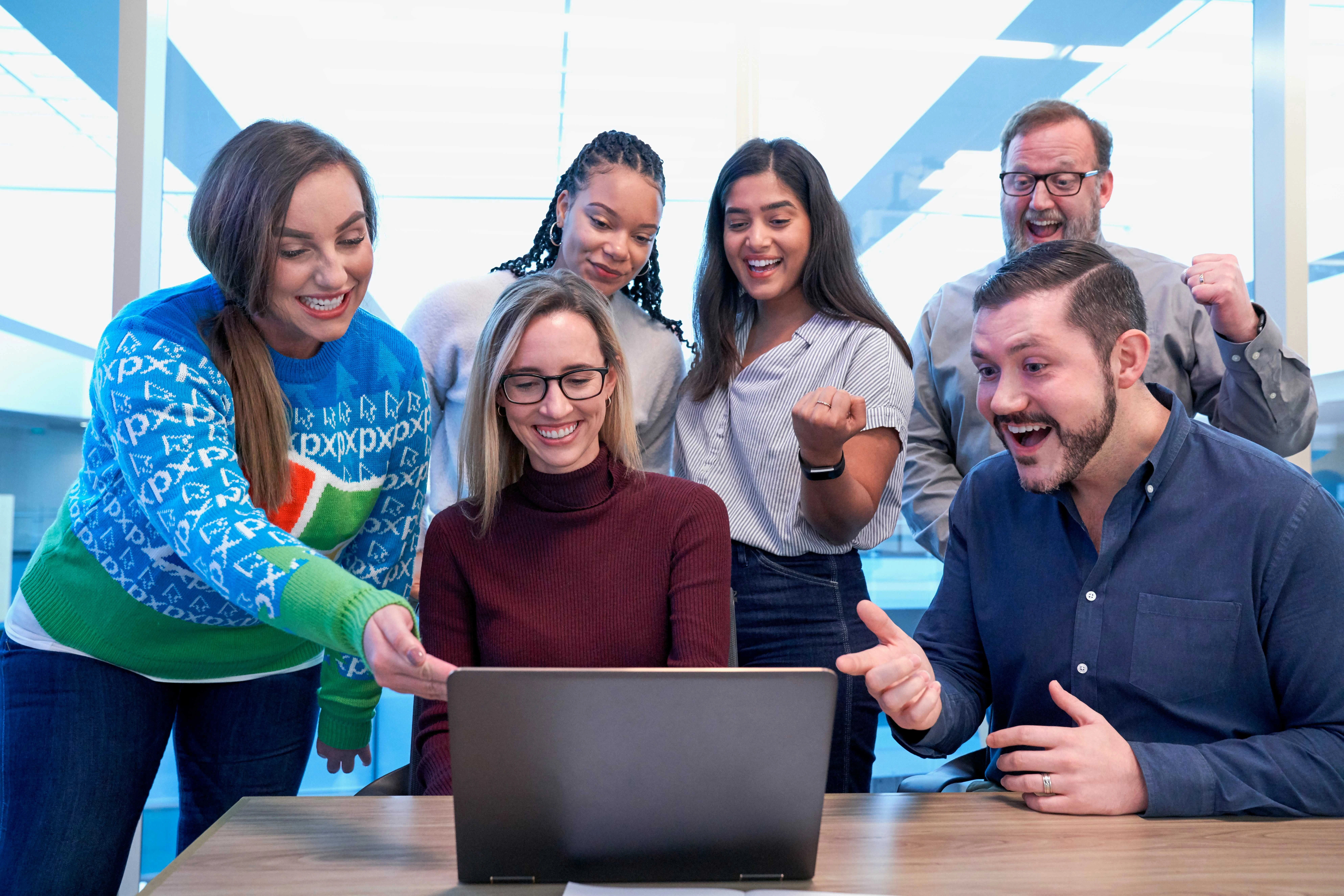 men-and-women-sitting-and-standing-while-staring-at-laptop men-and-women-sitting-and-standing-while-staring-at-laptop