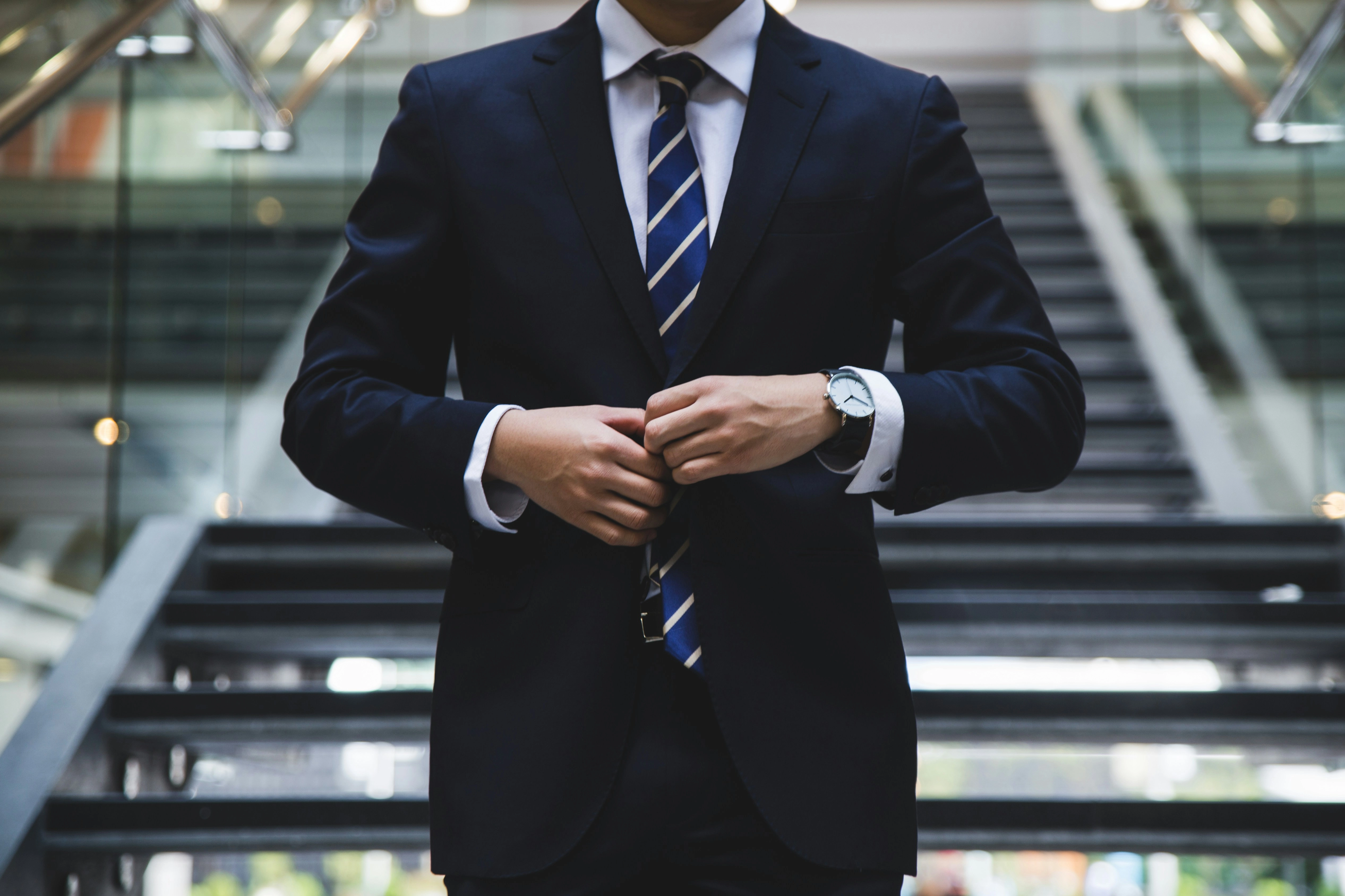 Professional businessman buttoning suit